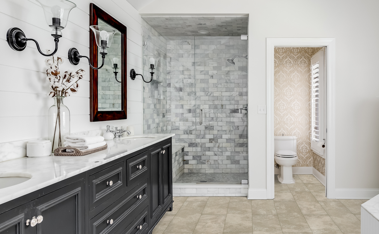 cream white neutral bathroom with walk-in tile shower and dark vanity